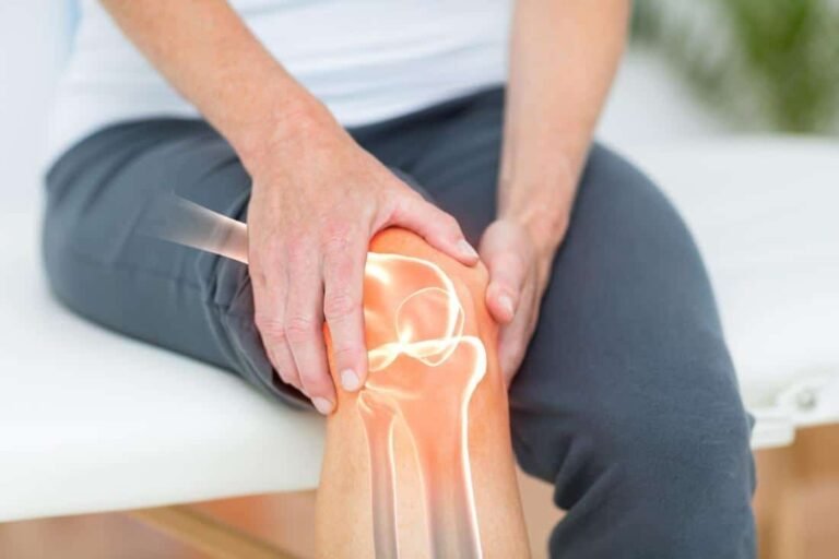 Patient holding a painful arthritic knee joint